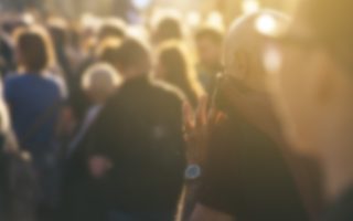 Defocused crowd attending political meeting