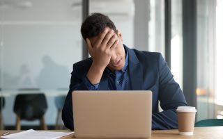 Business person looking shocked. By fizkes, Adobe Stock